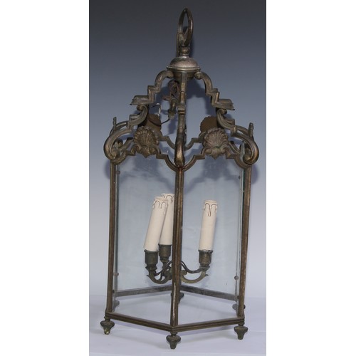 1306 - An early 20th century bronze hexagonal hall ceiling lantern, shaped arched crestings, each glazed pa... 