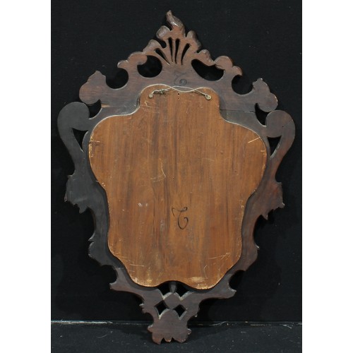 953 - A 19th century Continental walnut cartouche shaped looking glass, beveled mirror plate, the border c... 