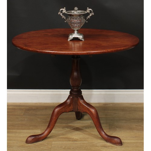 1235 - A George III mahogany tripod occasional table, one-piece circular tilting top, baluster column, cabr... 