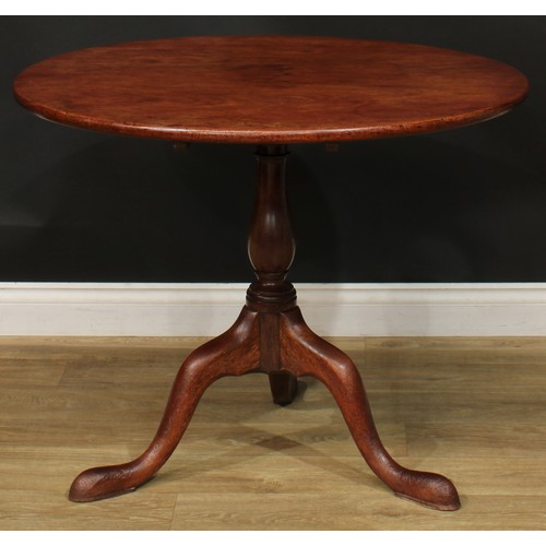 1235 - A George III mahogany tripod occasional table, one-piece circular tilting top, baluster column, cabr... 