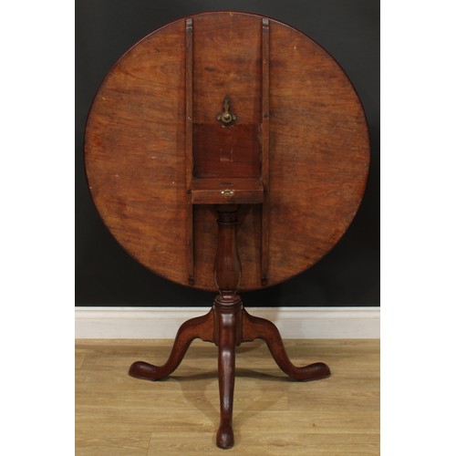 1235 - A George III mahogany tripod occasional table, one-piece circular tilting top, baluster column, cabr... 