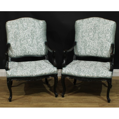 1401 - A pair of Louis XV Revival ebonised fauteuils, each with stuffed-over upholstery, shaped arms carved... 