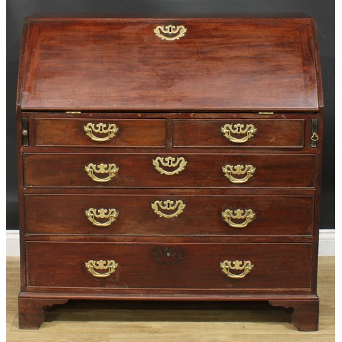 1106 - A George III mahogany bureau, fall front enclosing small drawers, pigeonholes and secret compartment... 