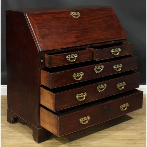 1106 - A George III mahogany bureau, fall front enclosing small drawers, pigeonholes and secret compartment... 