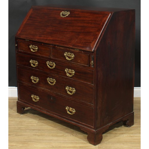 1106 - A George III mahogany bureau, fall front enclosing small drawers, pigeonholes and secret compartment... 