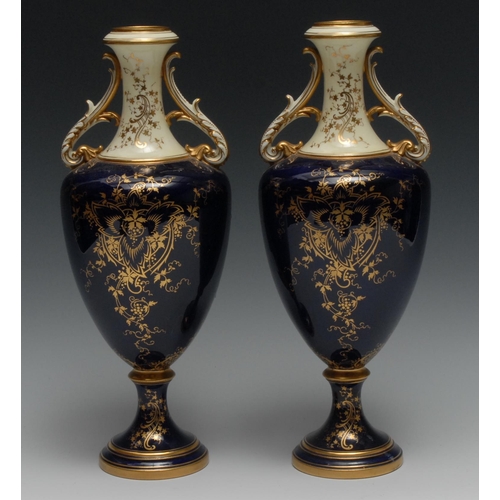 513 - A pair of Coalport two handled pedestal ovoid vases, painted by P. Simpson, signed, with ruins, with... 