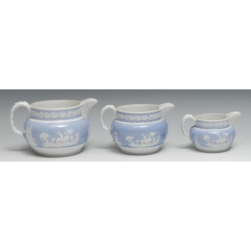 451 - A set of three English porcelain graduated  jugs, probably  Samuel Alcock, with applied in white cou... 