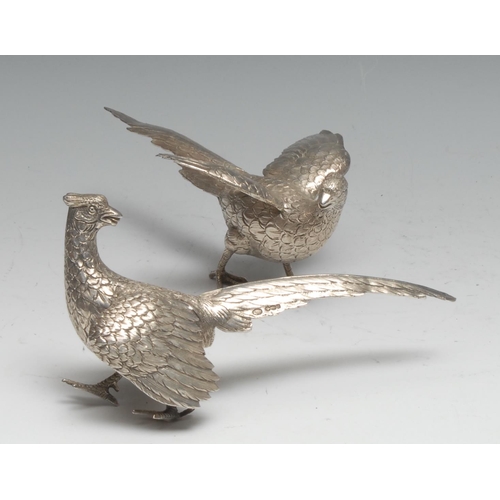 192 - A pair of German silver table decorations, as cock and hen pheasants, 18.5cm long, London import mar... 