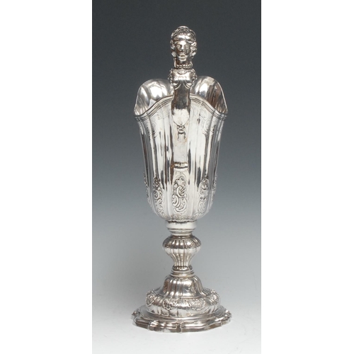 161 - A large Continental silver fluted helmet shaped pedestal ewer, the sculptural handle cast as a femal... 