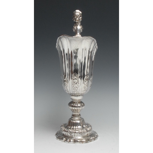 161 - A large Continental silver fluted helmet shaped pedestal ewer, the sculptural handle cast as a femal... 