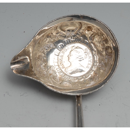 135 - A George III silver toddy ladle, 31cm long, apparently unmarked, the bowl set with a Queen Anne shil... 