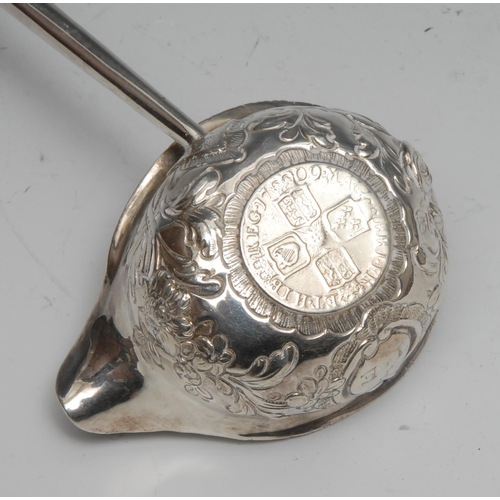 135 - A George III silver toddy ladle, 31cm long, apparently unmarked, the bowl set with a Queen Anne shil... 