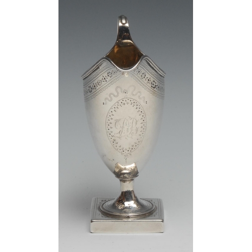 300 - Hester Bateman - a George III silver helmet shaped cream jug, bright-cut engraved and outlined with ... 