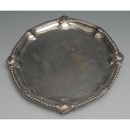 107 - A George II silver shaped circular salver, of substantial gauge, gadrooned shell border, plain field... 