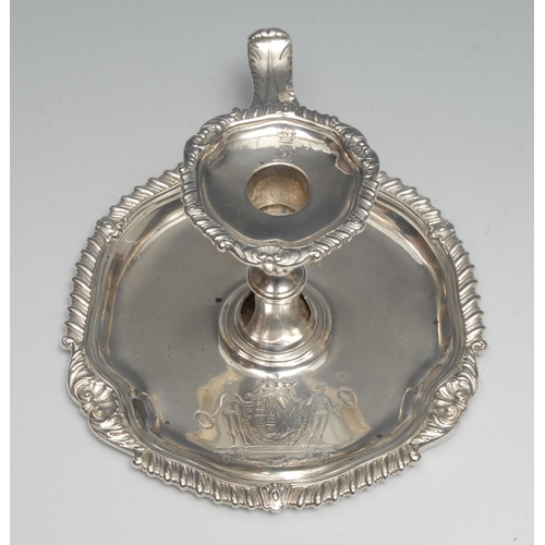 131 - A George III silver shaped circular chamber stick, gadrooned leafy scroll borders, half-fluted sconc... 