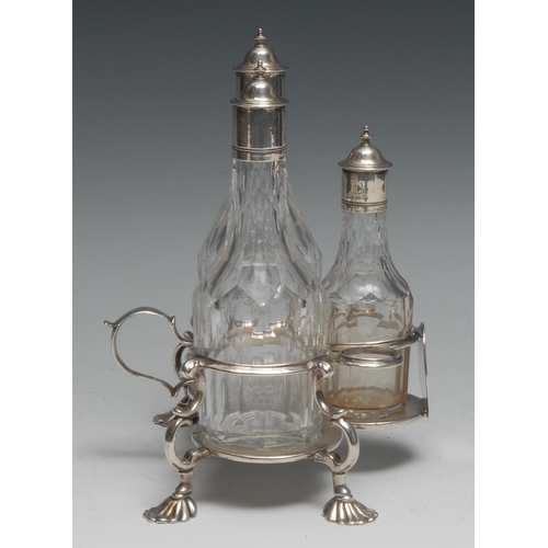 268 - An early George III silver three-bottle oil and vinegar cruet, scroll-capped handle, trefoil base, s... 