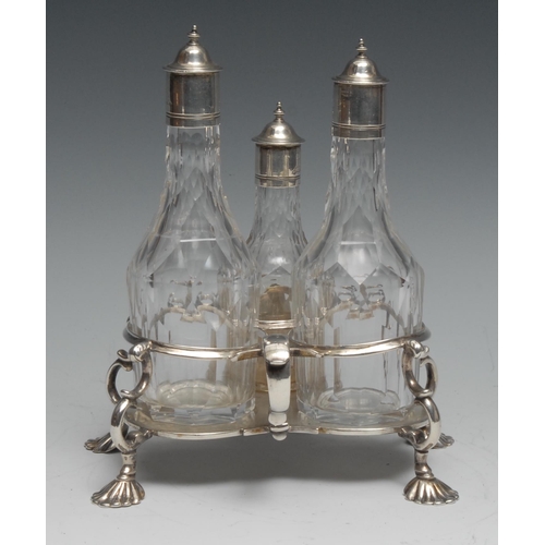 268 - An early George III silver three-bottle oil and vinegar cruet, scroll-capped handle, trefoil base, s... 