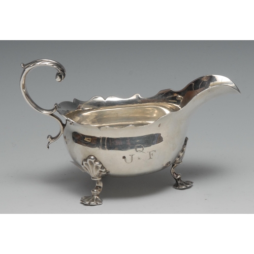 130 - A George III silver sauceboat, acanthus capped flying-scroll handle, wavy border, shell feet, 15.5cm... 