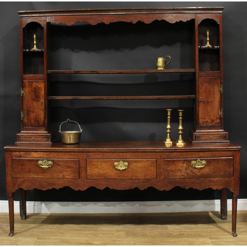 1268 - A George III oak dresser, possibly Shropshire, moulded cornice above a pair of plate racks, flanked ... 