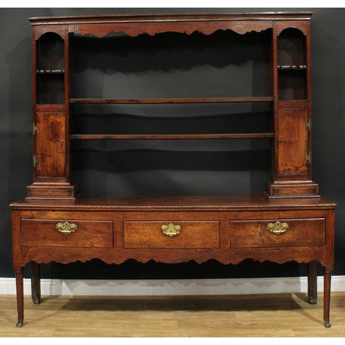 1268 - A George III oak dresser, possibly Shropshire, moulded cornice above a pair of plate racks, flanked ... 