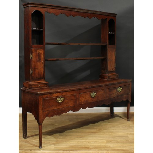 1268 - A George III oak dresser, possibly Shropshire, moulded cornice above a pair of plate racks, flanked ... 