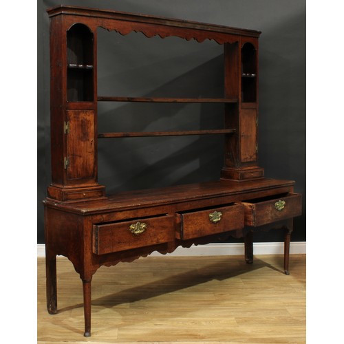 1268 - A George III oak dresser, possibly Shropshire, moulded cornice above a pair of plate racks, flanked ... 