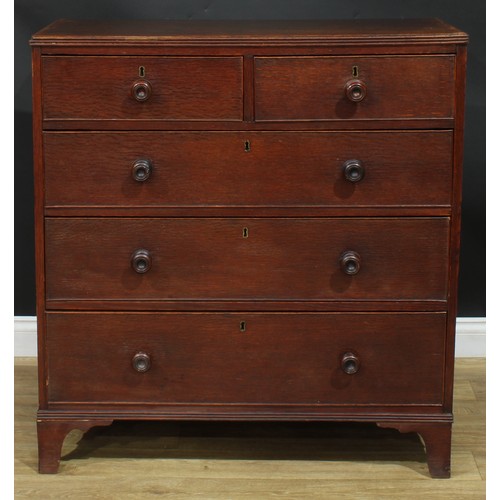 1243 - A George III oak chest, rectangular top above two short and three long graduated cockbeaded drawers,... 