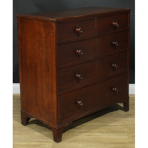 1243 - A George III oak chest, rectangular top above two short and three long graduated cockbeaded drawers,... 