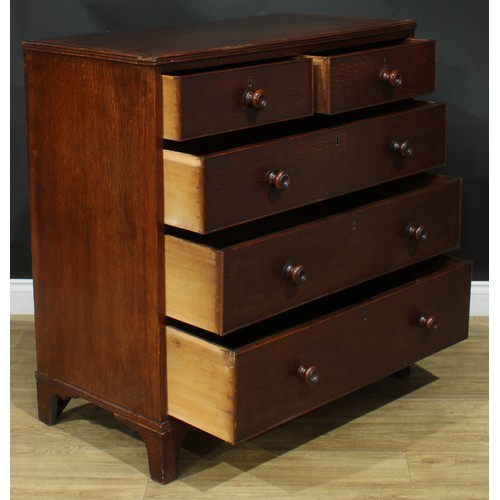 1243 - A George III oak chest, rectangular top above two short and three long graduated cockbeaded drawers,... 