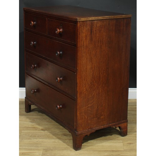 1243 - A George III oak chest, rectangular top above two short and three long graduated cockbeaded drawers,... 