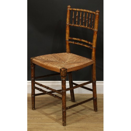 1129 - A set of three 19th century faux-bamboo side chairs, rush seats, 84.5cm high, 45cm wide, the seat 34... 