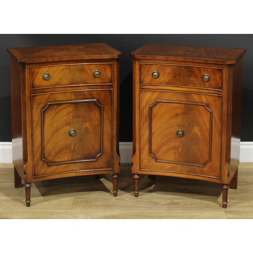 1395 - A pair of George III style inverted bowfront bedside cabinets, each with a slightly oversailing top ... 