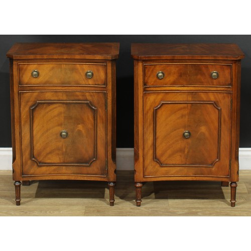 1395 - A pair of George III style inverted bowfront bedside cabinets, each with a slightly oversailing top ... 