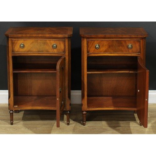 1395 - A pair of George III style inverted bowfront bedside cabinets, each with a slightly oversailing top ... 