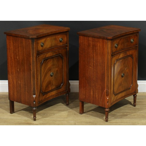 1395 - A pair of George III style inverted bowfront bedside cabinets, each with a slightly oversailing top ... 