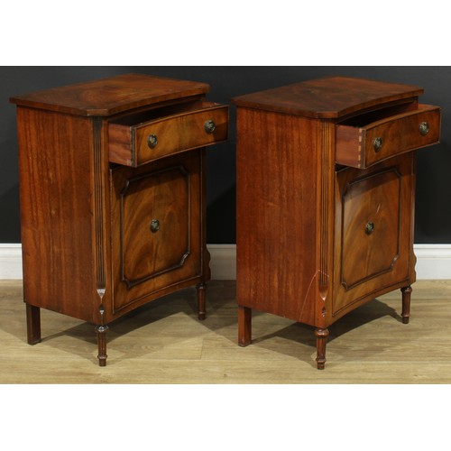 1395 - A pair of George III style inverted bowfront bedside cabinets, each with a slightly oversailing top ... 