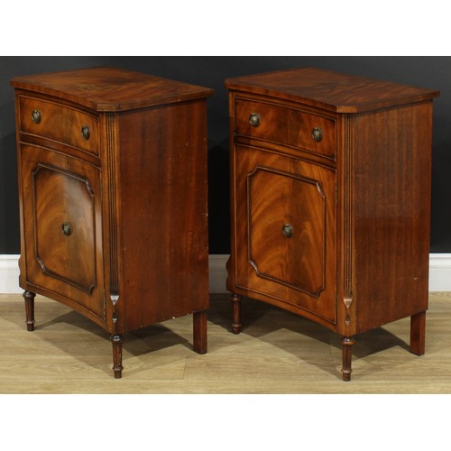 1395 - A pair of George III style inverted bowfront bedside cabinets, each with a slightly oversailing top ... 