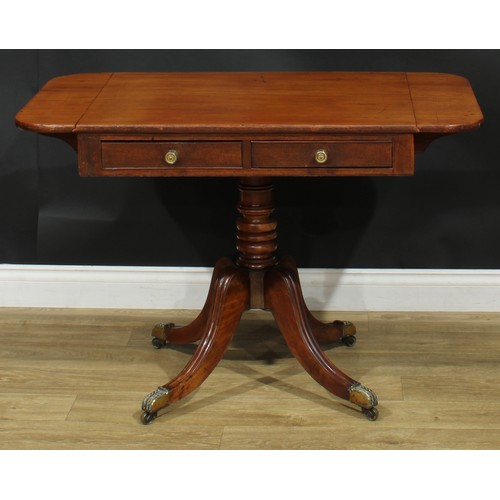 1405 - A pair of Regency mahogany sofa tables, each with a rounded rectangular top with fall leaves above a... 