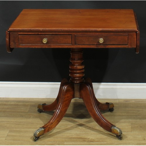 1405 - A pair of Regency mahogany sofa tables, each with a rounded rectangular top with fall leaves above a... 