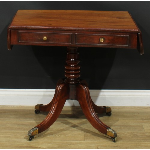 1405 - A pair of Regency mahogany sofa tables, each with a rounded rectangular top with fall leaves above a... 