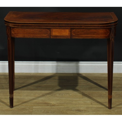 1394 - A pair of George III mahogany D-shaped card tables, each with a hinged crossbanded top enclosing a b... 