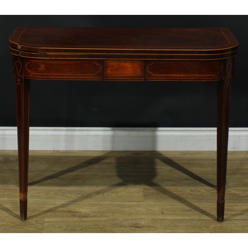 1394 - A pair of George III mahogany D-shaped card tables, each with a hinged crossbanded top enclosing a b... 