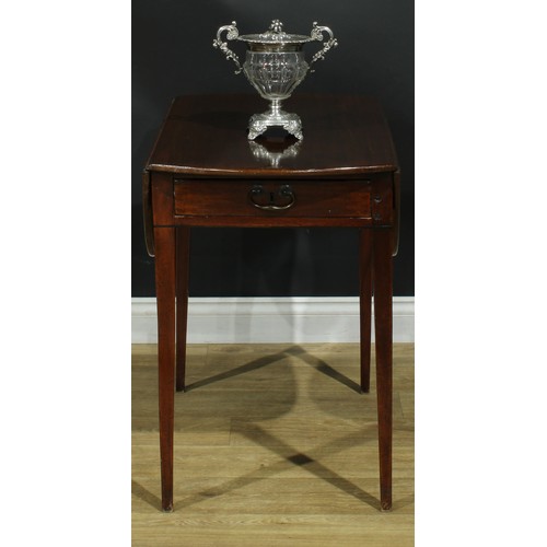 1225 - A George III mahogany Pembroke table, oval top with fall leaves above a frieze drawer, the verso con... 