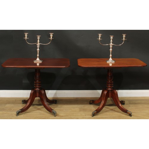 1404 - A pair of Regency mahogany occasional tables, each with a rounded rectangular top, turned column, sa... 