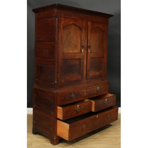 1269 - A George III oak housekeeper’s livery or provision cupboard, moulded cornice above a pair of panel d... 