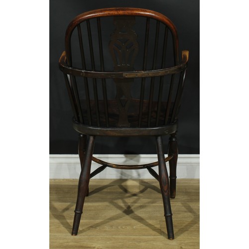 1122 - A set of four 19th century Windsor elbow chairs, each with a low hoop back, shaped and pierced splat... 