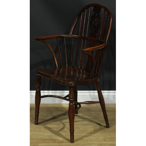 1122 - A set of four 19th century Windsor elbow chairs, each with a low hoop back, shaped and pierced splat... 