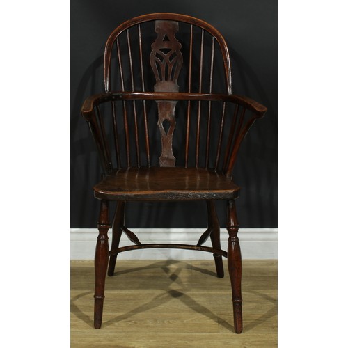 1122 - A set of four 19th century Windsor elbow chairs, each with a low hoop back, shaped and pierced splat... 