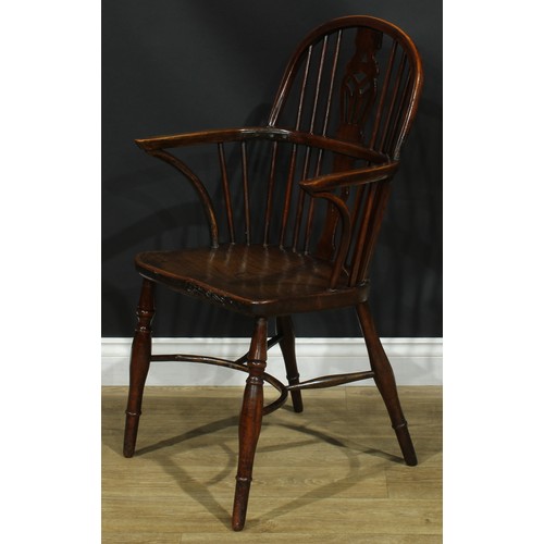 1122 - A set of four 19th century Windsor elbow chairs, each with a low hoop back, shaped and pierced splat... 