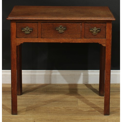 1166 - A George III oak lowboy or side table, rectangular top with moulded edge above three drawers, swing ... 